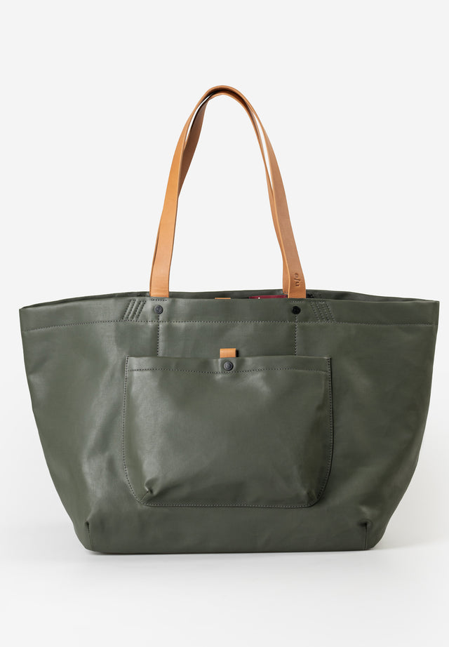 Green tote bag with brown handles on a white background