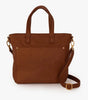 A brown leather tote bag with dual top handles, a front slip pocket, and a detachable shoulder strap, shown on a plain white background.